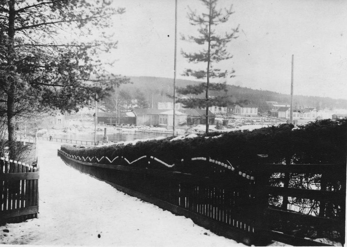 Punainen silta lähti Hiskinmäen saunan kupeelta ja päättyi vinosti virran ylitettyään länsirannan männikkörinteelle. Punaisen sillan jälkeen keskusta-aluetta kohti noustiin Kinttukujaa pitkin. Yläpäästään se jakaantui kahteen osaa: Oikeaa haaraa pitkin kuljettiin Wessmanin kaupalle ja toista haaraa pitkin pääsi Kuntalan ohitse Viiskulman laitaan. Kinttukujan eteläisellä puolella oli kuusiaita, jonka takana oli tehtaan puutarha ja vähän kauempana tehtaan klubi. Virran takana kuvan oikeassa reunassa on vanha rautatieaseman rakennus. Se oli myöhemmällä ajalla tehtaiden käytössä ja siellä pidettiin mm. erilaisia koulutustilaisuuksia. Rakennusta kutsuttiin myöhemmin puhekielessä Tenttukerhoksi. Siitä vasemmalle päin rivissä ovat 1900-luvun vaiheen tietämillä rakennetut Hiskinmäen asuinrakennukset. Aivan kuvan vasemmassa reunassa näkyy osa Hiskinmäen saunaa ja siitä oikealle veturitallit ja niiden edessä lussit, joista pieni palanen on säilynyt aina näihin päiviin saakka.