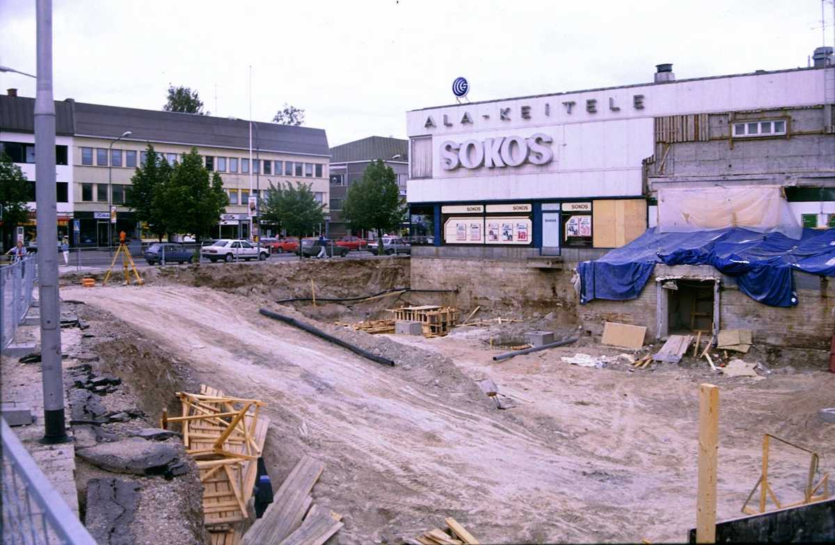 Nykyisen Tokmannin parkkihallin paikalla ollut liikerakennus. Talossa oli aikanaan mm. valokuvaliike, huonekalukauppa, Karhusen Heikin maaliliike, Litmasen sähköliike jne. Kiinteistö purettiin K-kaupan rakennuksen alta.